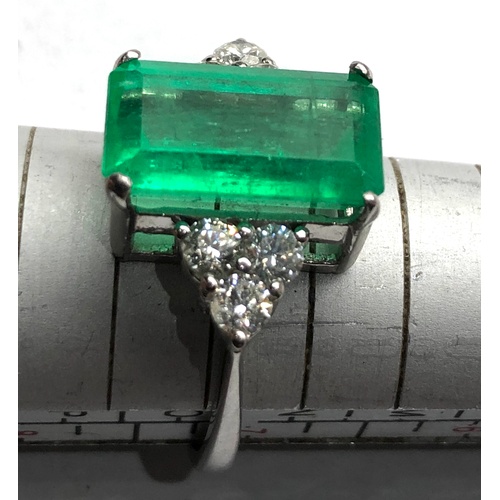 186 - Platinum Emerald and diamond ring large central emerald measures approx 15mm by 8.5mm set with  diam... 