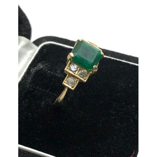 187 - 18ct diamond and emerald ring central emerald measures approx 8mm by 8mm with diamonds either side