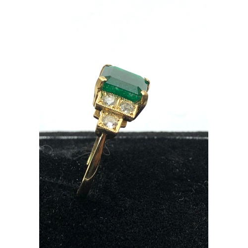 187 - 18ct diamond and emerald ring central emerald measures approx 8mm by 8mm with diamonds either side