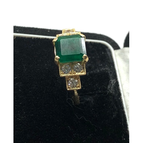 187 - 18ct diamond and emerald ring central emerald measures approx 8mm by 8mm with diamonds either side