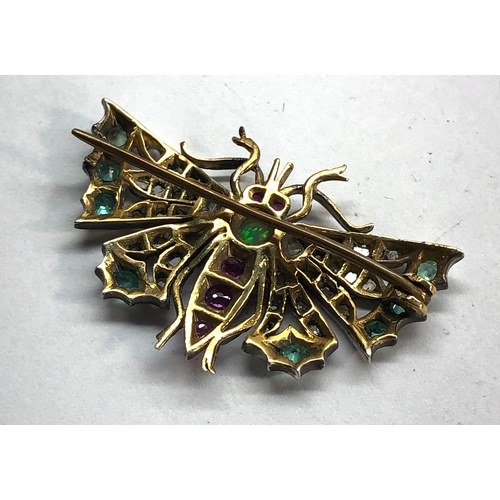 193 - Diamond emerald and ruby set butterfly brooch set in silver and gold backed measures approx 41mm by ... 