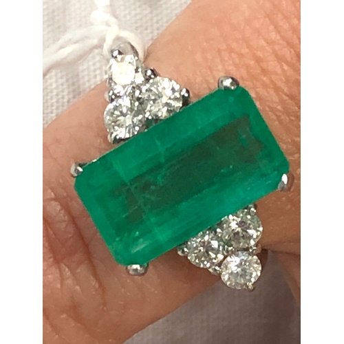 186 - Platinum Emerald and diamond ring large central emerald measures approx 15mm by 8.5mm set with  diam... 