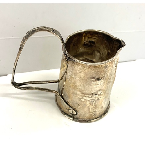 96 - Silver (tested) Small arts and crafts cream jug, no hallmarks, approximate measurements: 5.5cm, appr... 