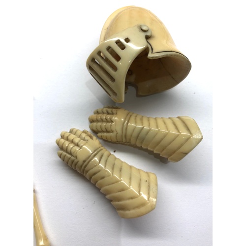 401 - 19th / 20th century Miniature carved ivory or bone knights helmet gloves sheild and weapons