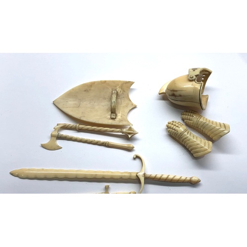 401 - 19th / 20th century Miniature carved ivory or bone knights helmet gloves sheild and weapons