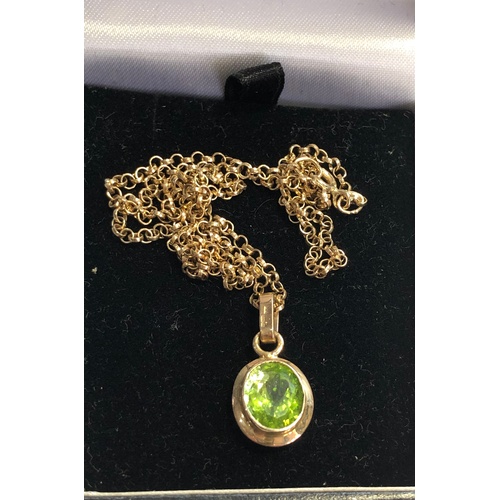 155 - 9ct Gold Peridot pendant and chain stone measures approx 10mm by 9mm with a gold chain that measures... 