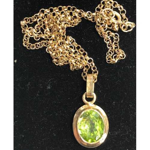 155 - 9ct Gold Peridot pendant and chain stone measures approx 10mm by 9mm with a gold chain that measures... 