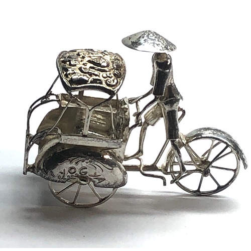 109 - Dutch silver miniature china man on bike and carriage  tests as silver