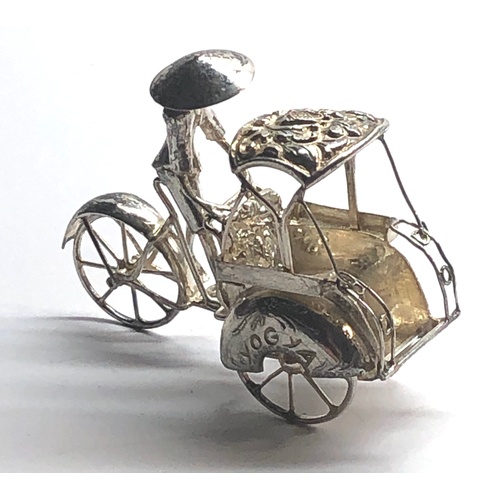 109 - Dutch silver miniature china man on bike and carriage  tests as silver