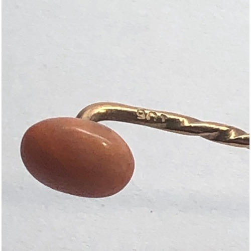 186 - Antique coral bead stick pin coral measures approx 9mm by 7mm with a 9ct gold pin length 57mm