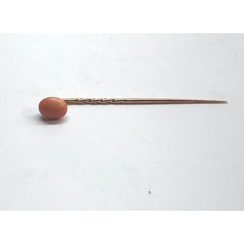 186 - Antique coral bead stick pin coral measures approx 9mm by 7mm with a 9ct gold pin length 57mm