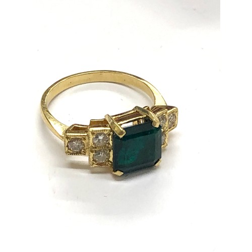 215 - 18ct diamond and emerald ring central emerald measures approx 8mm sq with diamonds each side