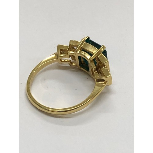 215 - 18ct diamond and emerald ring central emerald measures approx 8mm sq with diamonds each side