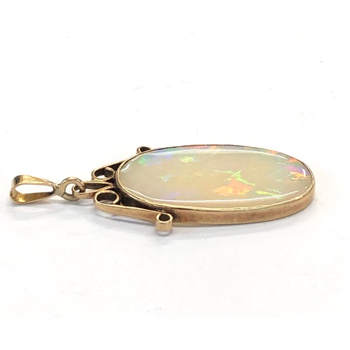 225 - Large opal pendant opal measures approx 36mm by 24mm set in gold mounted pendant