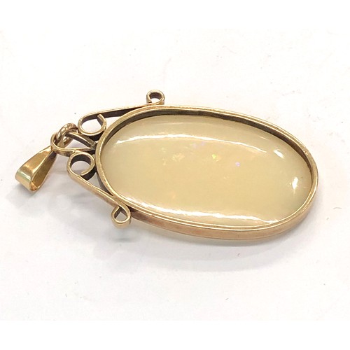 225 - Large opal pendant opal measures approx 36mm by 24mm set in gold mounted pendant