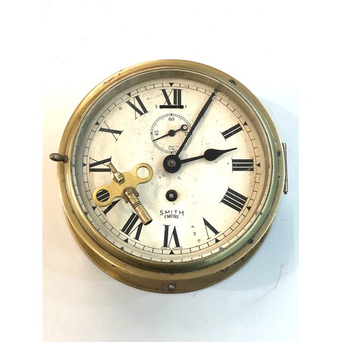 387 - Vintage Smiths Empire ships bulkhead clock the clock winds and ticks but no warranty given measures ... 