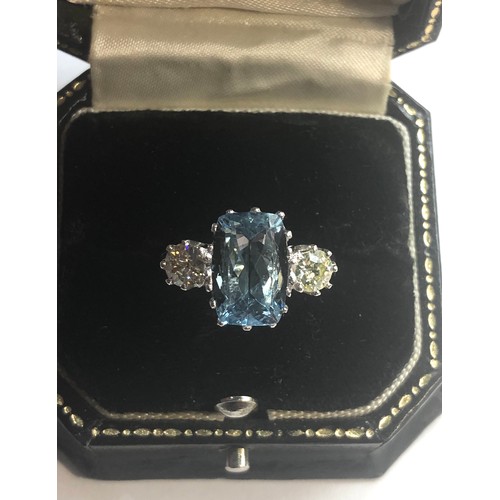 239 - Diamond and aquamarine ring central aquamarine measures approx 12mm by 8mm  the 2 diamonds measure a... 