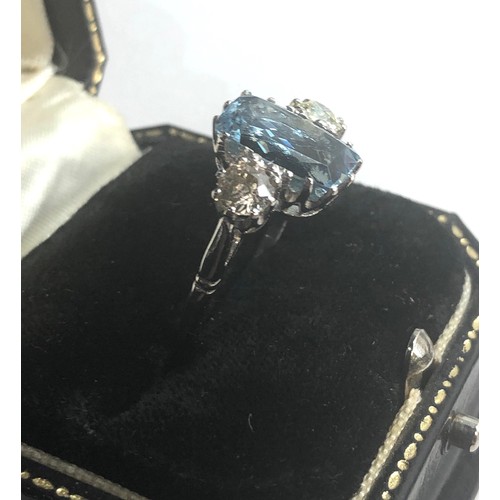 239 - Diamond and aquamarine ring central aquamarine measures approx 12mm by 8mm  the 2 diamonds measure a... 