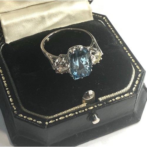 239 - Diamond and aquamarine ring central aquamarine measures approx 12mm by 8mm  the 2 diamonds measure a... 