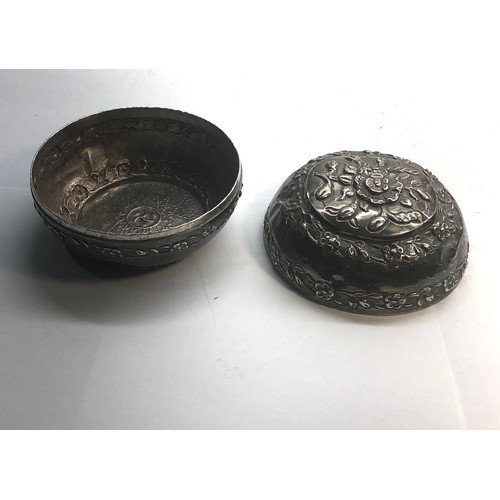 18 - Asian silver lidded bowl floral embossed design measures approx 9.2cm dia  not hallmarked but has be... 