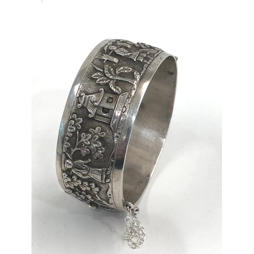 88 - Fine vintage Chinese silver bangle embossed with Chinese scenes measures approx 25mm wide by 6cm dia... 