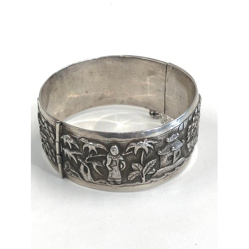 88 - Fine vintage Chinese silver bangle embossed with Chinese scenes measures approx 25mm wide by 6cm dia... 