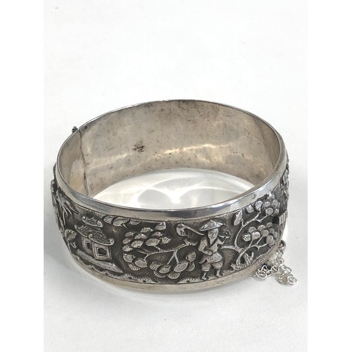 88 - Fine vintage Chinese silver bangle embossed with Chinese scenes measures approx 25mm wide by 6cm dia... 