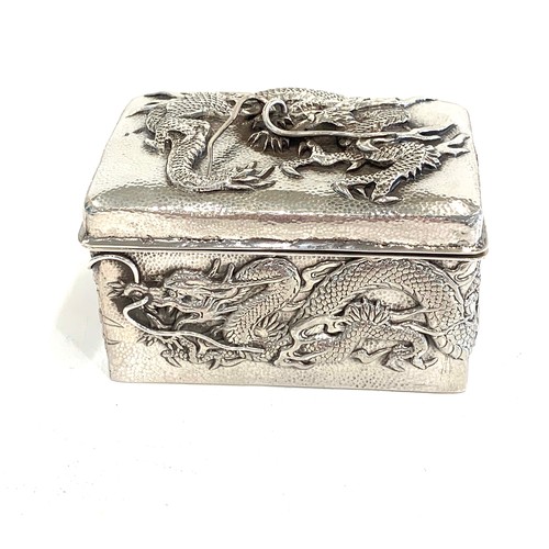 109 - Japanese silver box depicting dragons, approximate measurements: Width 7.5cm, Depth 5cm, Height 4.5c... 