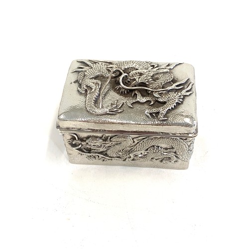 109 - Japanese silver box depicting dragons, approximate measurements: Width 7.5cm, Depth 5cm, Height 4.5c... 