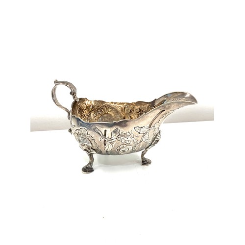 110 - 18th century, Irish silver chased sauce boat, approximate measurements: 16cm width by height 9 cm, a... 