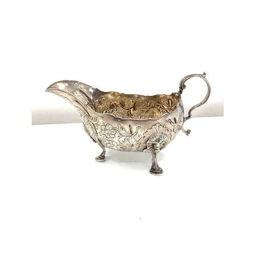 110 - 18th century, Irish silver chased sauce boat, approximate measurements: 16cm width by height 9 cm, a... 