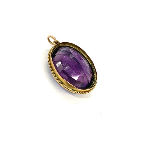 148 - Antique gold mounted amethyst pendant measures approx 3cm by 2.3cm