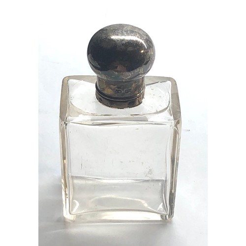 84 - Silver top perfume bottle with glass stopper measures approx height 11cm in good condition