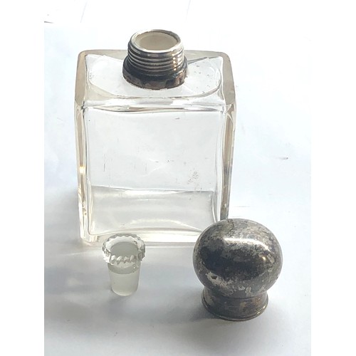 84 - Silver top perfume bottle with glass stopper measures approx height 11cm in good condition