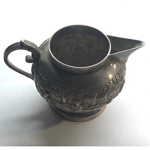 46 - Large vintage asian silver embossed milk jug not hallmarked but tested as silver measures approx 13.... 