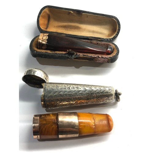 432 - 2 gold mounted amber cheroot holders cased n silver and leather cases age related wear and damage