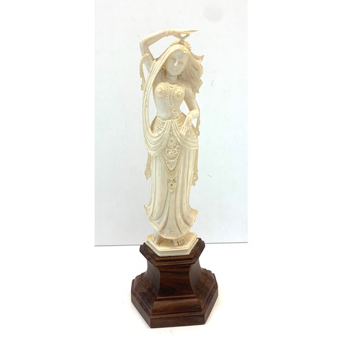 437 - Carved bone figure on wooden stand measures approx  26cm please see images for details