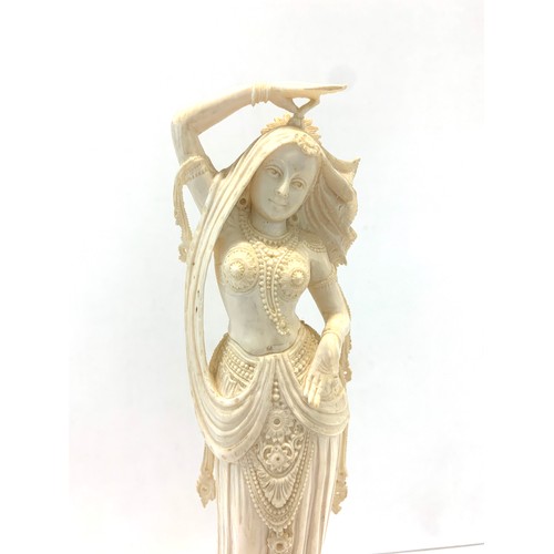 437 - Carved bone figure on wooden stand measures approx  26cm please see images for details