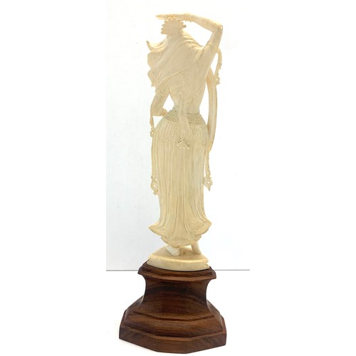 437 - Carved bone figure on wooden stand measures approx  26cm please see images for details