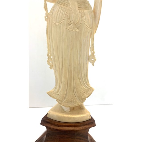 437 - Carved bone figure on wooden stand measures approx  26cm please see images for details