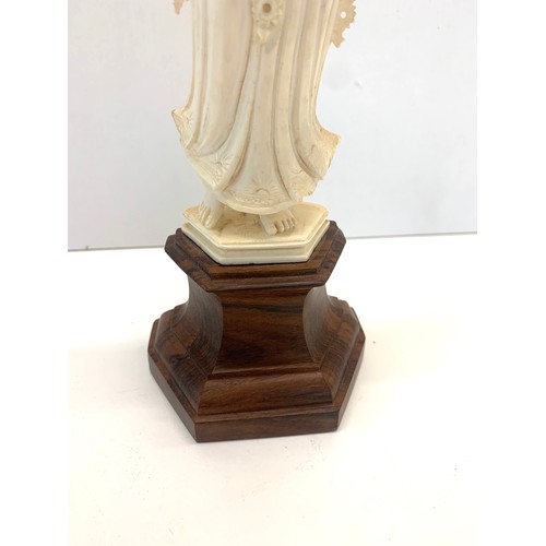 437 - Carved bone figure on wooden stand measures approx  26cm please see images for details