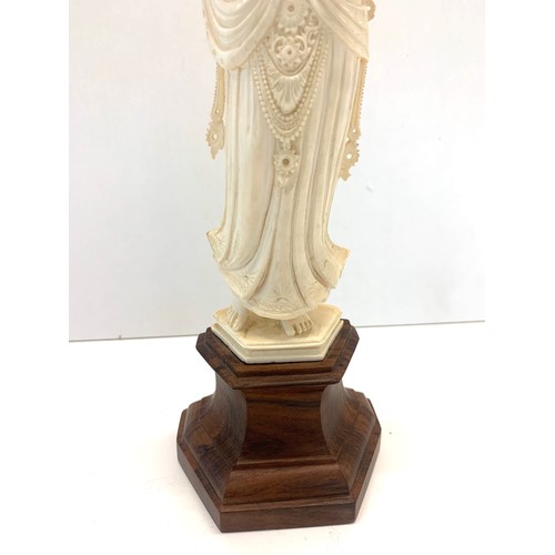 437 - Carved bone figure on wooden stand measures approx  26cm please see images for details