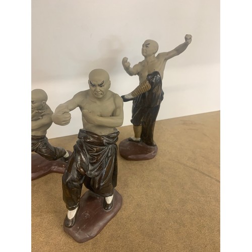 65 - 4 Oriental fighting figures, all in good overall condition