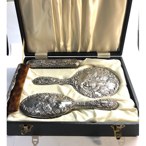 17 - Boxed silver mirror and brush set with cherub  embossed backs