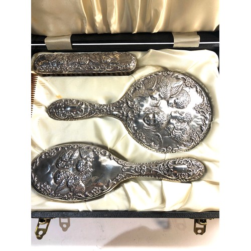 17 - Boxed silver mirror and brush set with cherub  embossed backs