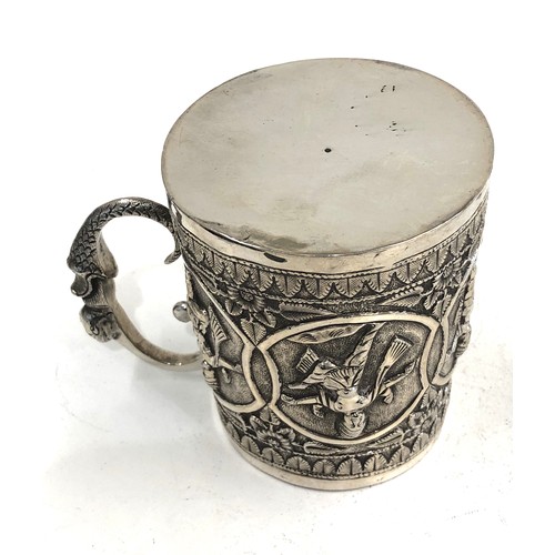 17 - Antique Indian silver embossed mug height 8.5cm weight 153g