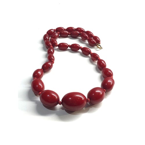 106 - Antique Cherry amber / bakelite bead necklace largest bead measures approx 21mm by 16mm graduated be... 