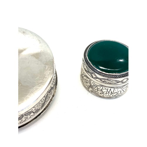 57 - 2 Persian silver boxes larget measures approx 6.3cm dia weight 90g the other set with green stone 3.... 