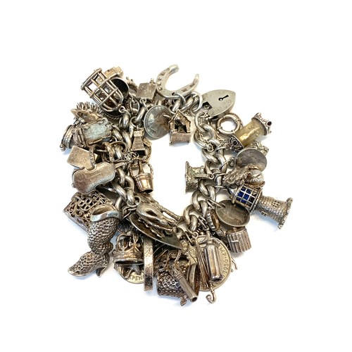 135 - Huge vintage silver charm bracelet and charms