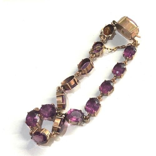 333 - 9ct gold amethyst coloured gem set bracelet